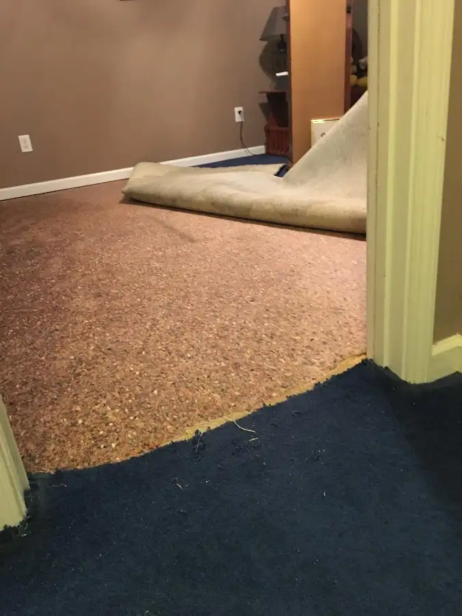 Carpet pad removal revealing water damage during Drying & Dehumidification in Grand Island